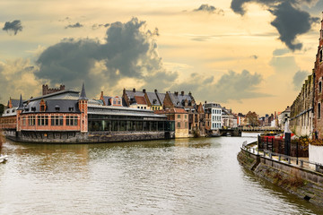 Golden sunset and dramatic clouds over historic buildings in medieval Belgian city Ghent - one of the most attractive touristic places in Europe