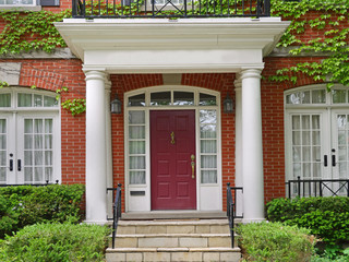 Vine covered house with portico entrance