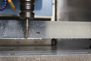 The CNC milling machine cutting the tire mold part with the solid ball end-mill tool and coolant.