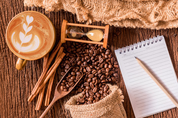 brown coffee cup and roasted coffee beans around