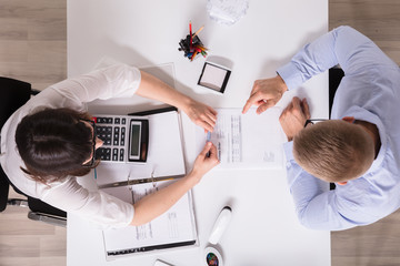 Two Businesspeople Analyzing Bill