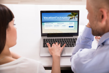 Couple Filling Online Vacation Packages Form
