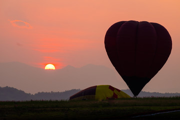 Silhouette of hot air balloons with sunset.