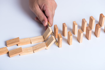 man hand using a pen stop domino falling effect, using idea to solve the problem