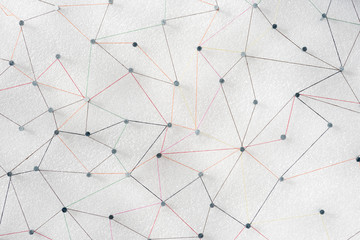 abstract web line connection of color yarn from nail node to node on white background , networking concept