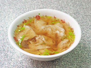 Wonton soup  in a bowl. Traditional asian food.