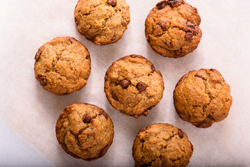 Homemade Banana Muffins with chocolate chips sitting on a grease paper