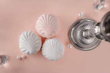 Three pieces of zephyr on a pink pastel background. Top view.