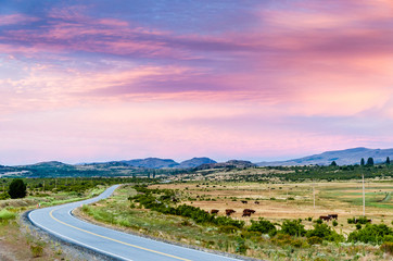 Pink sky and the road to the mountains