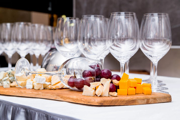 a composition from a wine glass and cheese on a buffet table