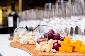 a composition from a wine glass and cheese on a buffet table