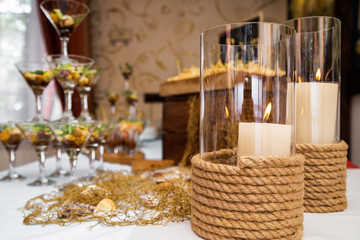 Fourchette table decorated in a marine style, candles on the table