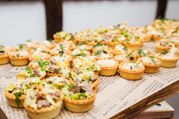 tartlets with salad on the table