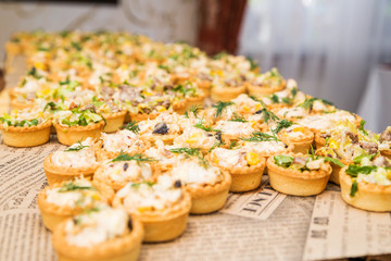 tartlets with salad on the table