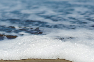 Obraz premium Ocean foam on the sand