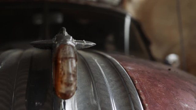 Old Car Hood Ornament Pontiac. Slow motion hand held.