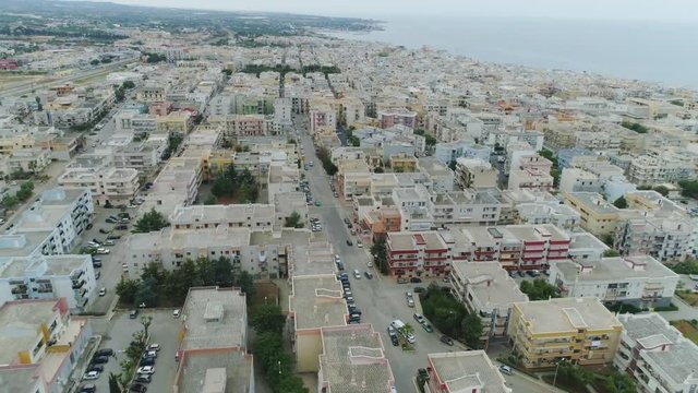 Car drive through the city in Italy Drone flight 4k