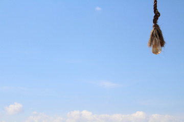 The rope and the bulb. Taken during a sunny day, with perfect blue sky in Bali,
