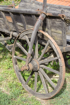Old wheel wooden cart in the garden. Hungary