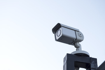 Street surveillance camera on the fence.