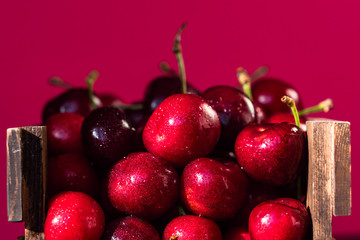 Fresh sweet cherries in a wooden box close