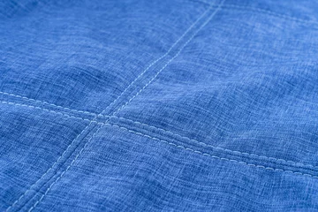 Fotobehang Fabric texture with seam stitch seam. © Dmytro Holbai