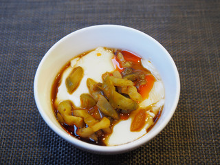 Tofu with  soya sauce on white bowl