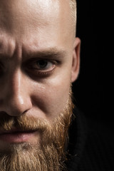 portrait of a brutal man close-up on a black background
