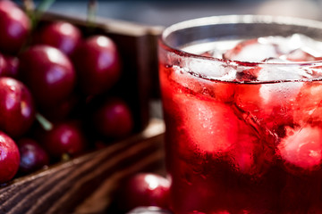 Fresh cherries in a wooden box, ice, cherry juice