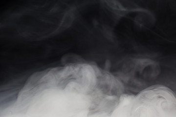 Cloud of white smoke on a black background closeup