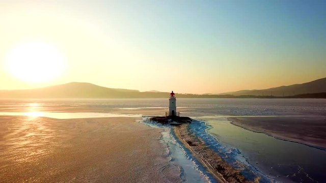Aerial winter view of the Tokarevskiy lighthouse - one of the oldest lighthouses in the Far East, still an important navigational structure and popular attractions of Vladivostok city, Russia.