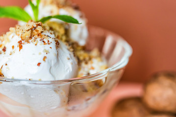 Vanilla ice cream in bowl and walnuts