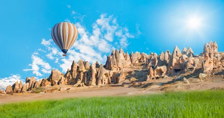 Gordijnen Hot air balloon flying over spectacular Cappadocia  © muratart