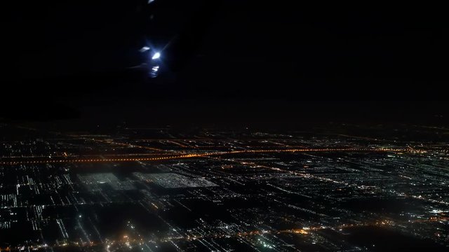 Bangkok, Thailand- Jun 4, 2018. Thai Airasia airline flight FD 3010 fly from Phuket (HKT) to Donmuang Bangkok (DMK) is landing. View from window seat Illuminated city in dark night. 