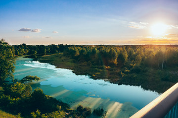 Summer sunset with the river and forest