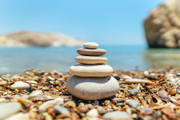 Stack of stones on the beach near sea