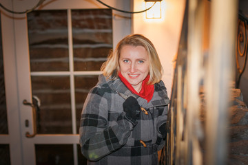 Night portrait blonde girl in a warm coat