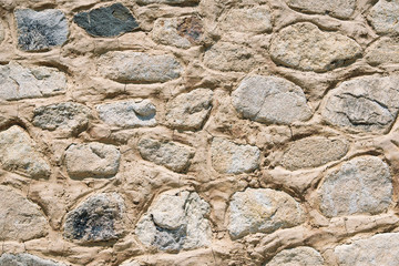 Old stone wall background texture closeup