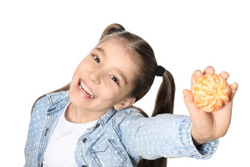 Funny little girl with citrus fruit on white background