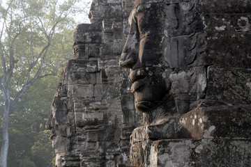 Siem Reap Cambodia,  Anthropomorphic  faces carved into stone at the  Bayon Wat, a 12th century temple within the Angkor Thom complex