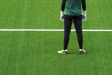 Soocer goalkeeper on green grass  background