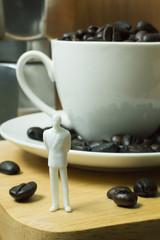 The white miniature and coffee beans vintage mood and tone.