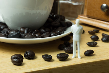 The white miniature and coffee beans vintage mood and tone.