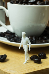 The white miniature and coffee beans vintage mood and tone.