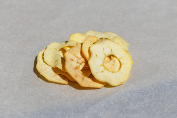 Dried apple, cut into flakes, on white background