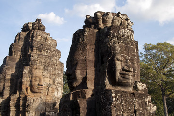 Siem Reap Cambodia,  Anthropomorphic  faces carved into stone at the  Bayon Wat in late afternoon light, a 12th century temple within the Angkor Thom complex