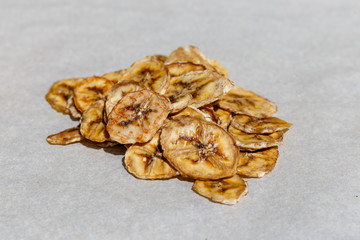 Dried banana, cut into flakes, on white background