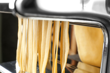 Metal pasta maker with dough, closeup