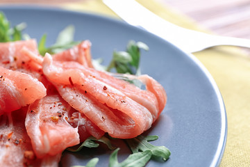 Bacon with arugula on plate, closeup