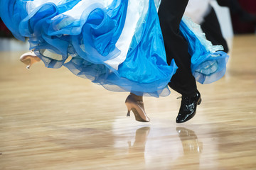 Beautiful womanish and masculine legs in active ballroom dance, indoors - obrazy, fototapety, plakaty